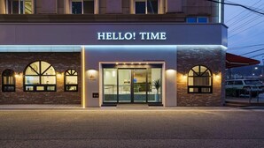 A hotel entrance with a sign reading "HELLO! TIME". - Gumi Time Hotel (Gumi)