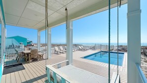 A covered deck with a pool, lounge chairs, and a table. - BEACHFRONT, PRIVATE HOUSE, PRIVATE POOL, PRIVATE BEACH ACCESS! (Gulf Shores)