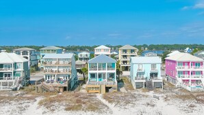 A beachfront property with multiple multi-story buildings, each featuring balconies and a beachside location. - BEACHFRONT, PRIVATE HOUSE, PRIVATE POOL, PRIVATE BEACH ACCESS! (Gulf Shores)