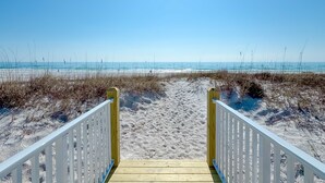 A wooden pathway leading to a beach with a clear blue sky. - BEACHFRONT, PRIVATE HOUSE, PRIVATE POOL, PRIVATE BEACH ACCESS! (Gulf Shores)