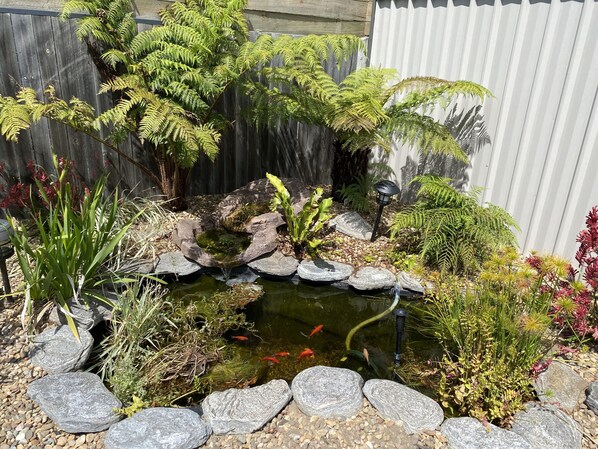 Surrounded by lush greenery and a serene pond, this garden offers a peaceful escape.