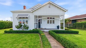 A two-story house with a porch, a small front yard, and a pathway leading to the entrance. - The Anchor House - Perfect Gem in the centre of Port Fairy (Port Fairy)