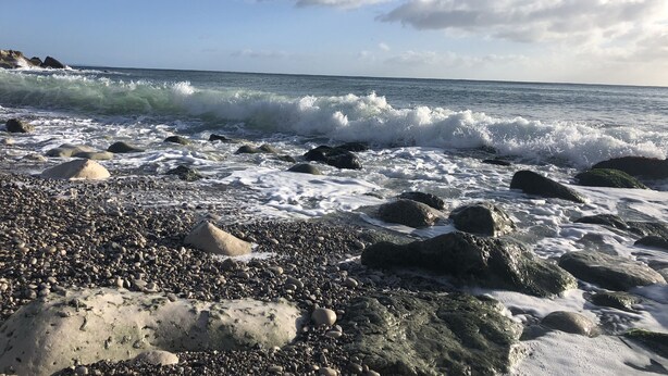 A rocky beach with waves crashing onto the shore. - Kimberlin (Portland)