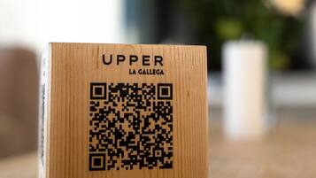A wooden box with a QR code and text on it.