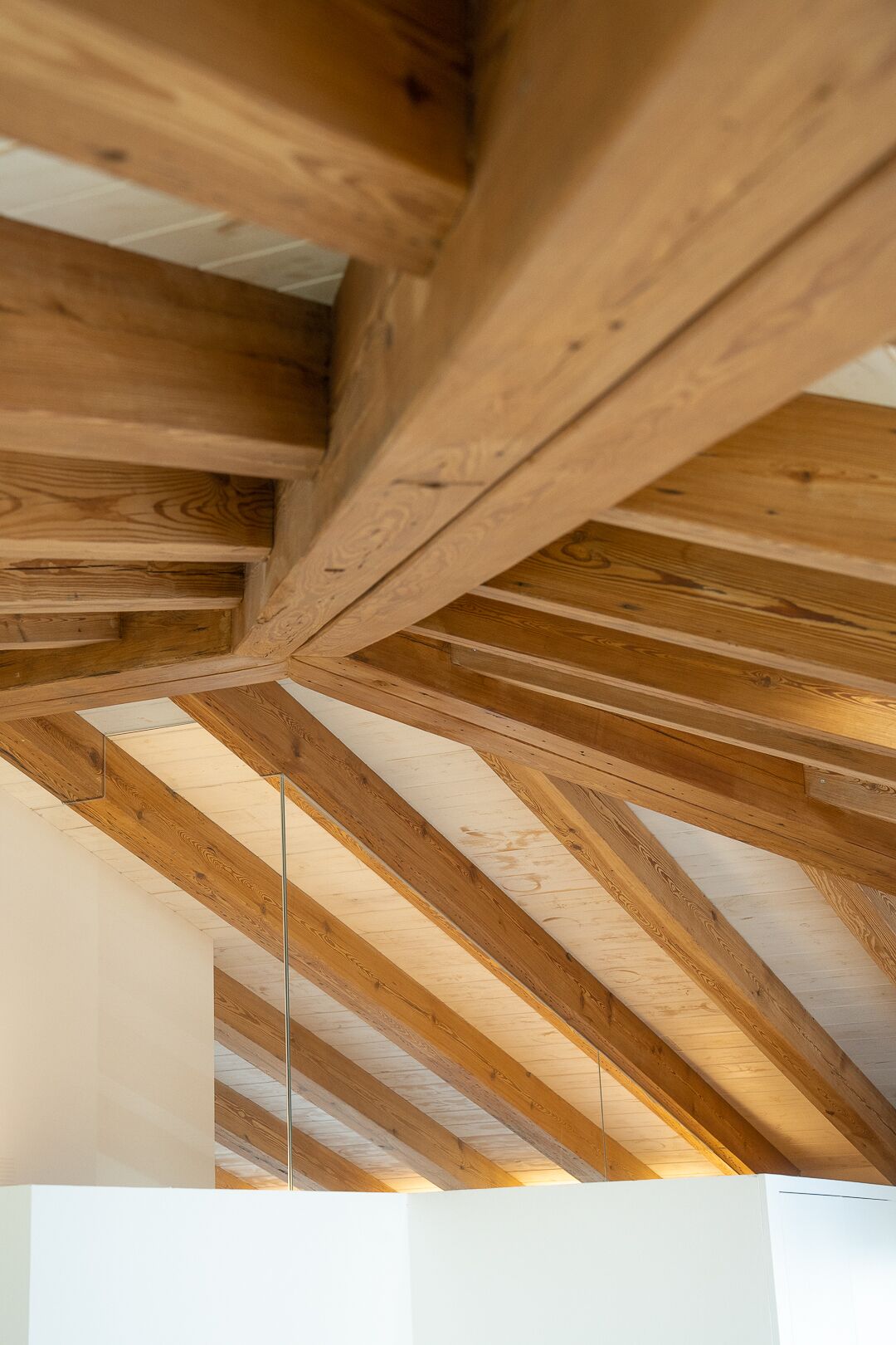 A wooden ceiling structure with exposed beams.