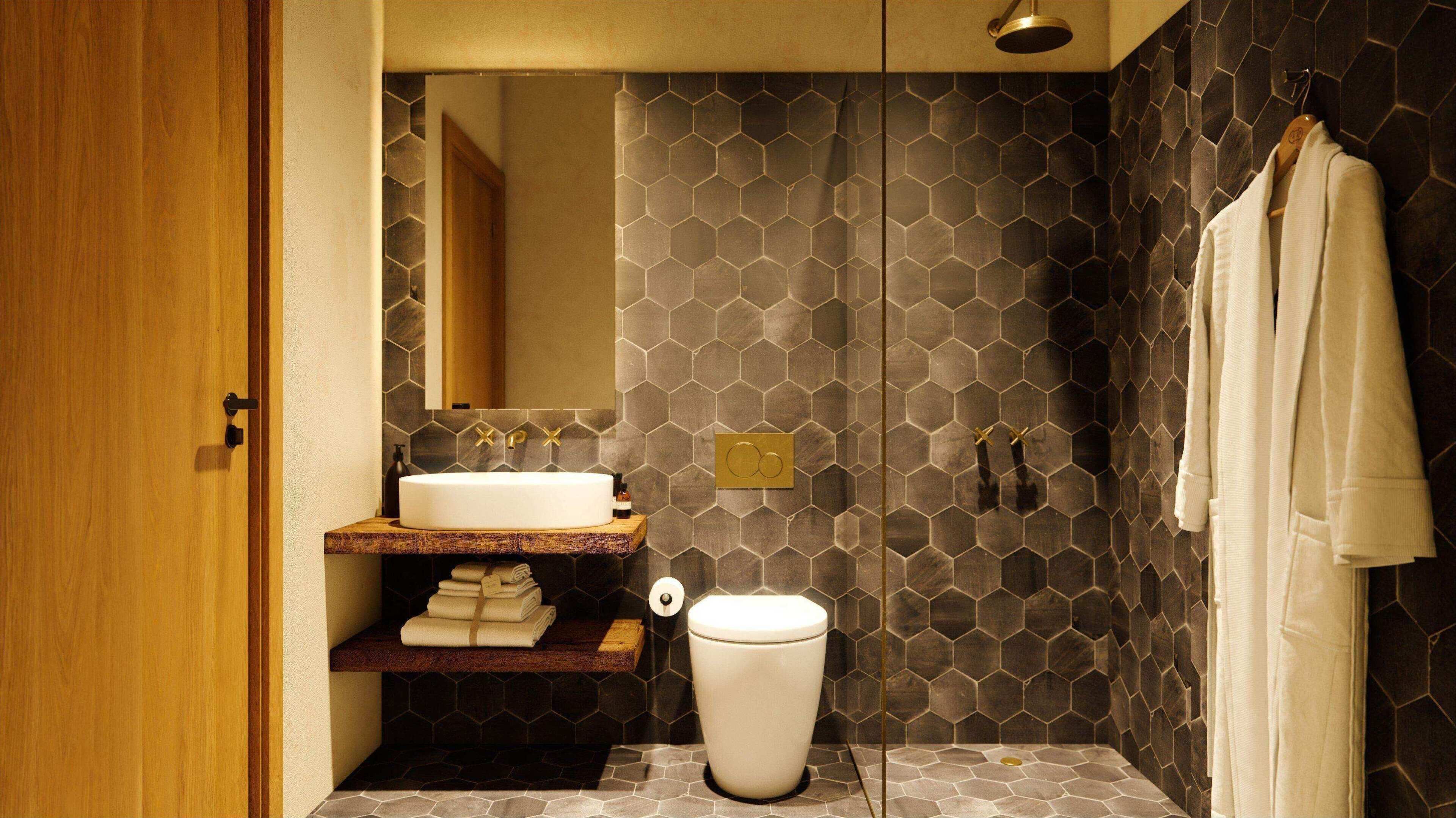 Un baño moderno con tocador de madera, un lavabo blanco y un inodoro.