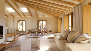Een ruime woonkamer met een hoge nok, houten balken, een eethoek met stoelen en een tafel, en een bank met kussens.