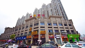 A multi-story hotel with a prominent entrance and several visible signs indicating various services and amenities. - Super 8 (Ningde Wanda Plaza) (Ningde)