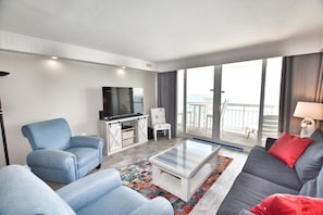 Enjoy a city view from the large balcony, relax in the seating area with a sofa and armchairs, and unwind with a flat-screen TV.