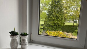 A window with two decorative vases on a white sill. - The Ramblers Rest - whole apartment, pet friendly, close to amenities/walks. (Edzell)