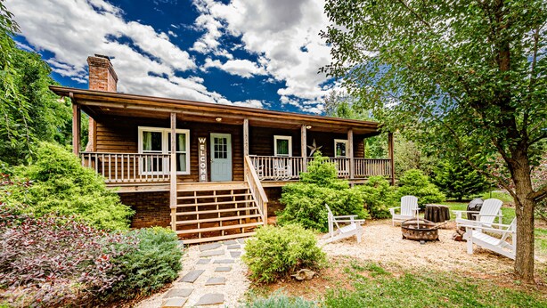 A wooden cabin with a porch, stone pathway, and outdoor seating. - Tatum's Mtn View Retreat- SAUNA-Hiking- Unit A (Madison)