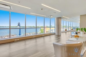 Enjoy a panoramic view of the water and a distant landmark from this spacious room with a comfortable seating area.