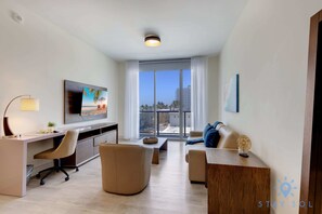 TV, offices - Beachside Luxe: Modern Condo, Rooftop Pool (Hollywood)