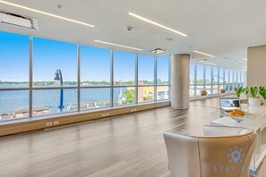 Enjoy a panoramic view of the water and distant landmark from this stylish room with a comfortable seating area.