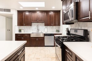 Enjoy cooking in this well-equipped kitchen with a dishwasher, oven, and microwave, plus ample counter space for food preparation.