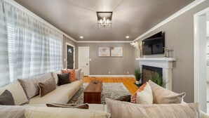 A living room with a sofa set, a coffee table, and a fireplace.