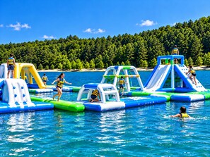 An inflatable water park with various play structures and slides.