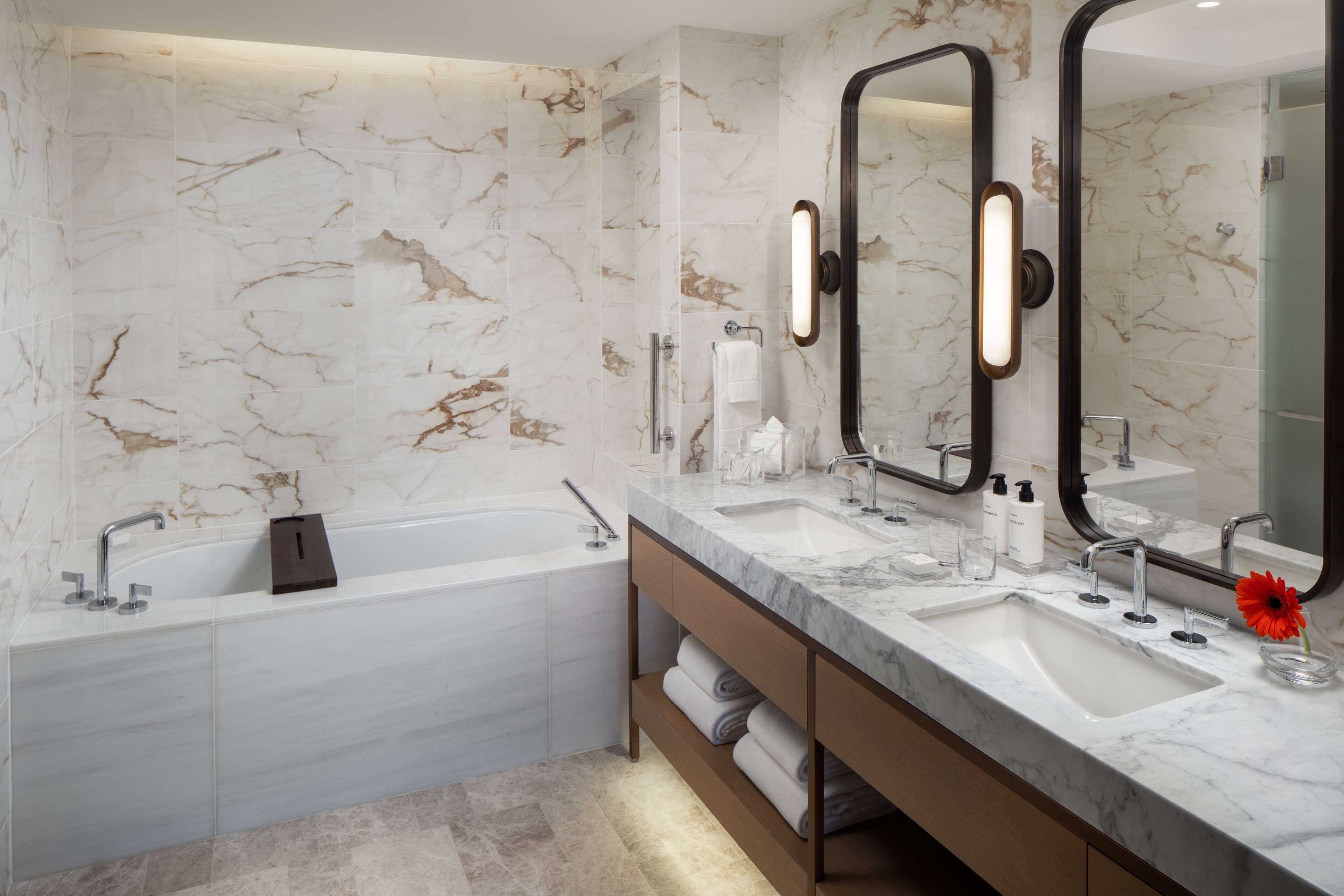 deep-soaking bathtub, rainfall showerhead, designer toiletries