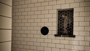 A wall with a hexagonal patterned window and a circular sign. - The Baker Hotel (Cranbrook)