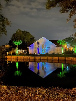 Situated beside a calm body of water, this building offers a serene atmosphere.