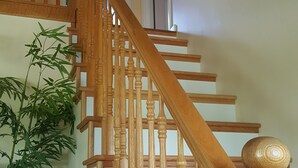 A wooden staircase with a handrail, a door at the top, and a potted plant beside it. - Porch sunset on the lake, 1/2 mile from Beaver Creek Marina! (Monticello)