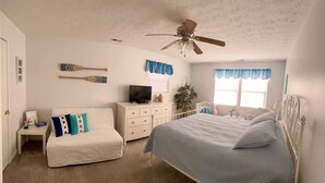 A bedroom with a bed, a white dresser, a television, a ceiling fan, and a window with curtains. - Porch sunset on the lake, 1/2 mile from Beaver Creek Marina! (Monticello)