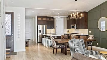 A spacious kitchen with dark wooden cabinets, a central island, and modern appliances.