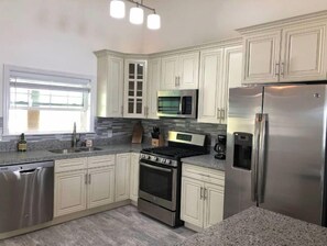 Enjoy cooking in this well-equipped kitchen with a gas range, microwave, and dishwasher.