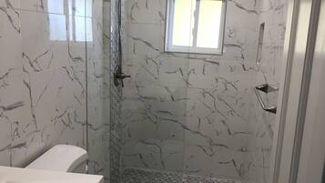 Shower, hair dryer, towels, toilet paper