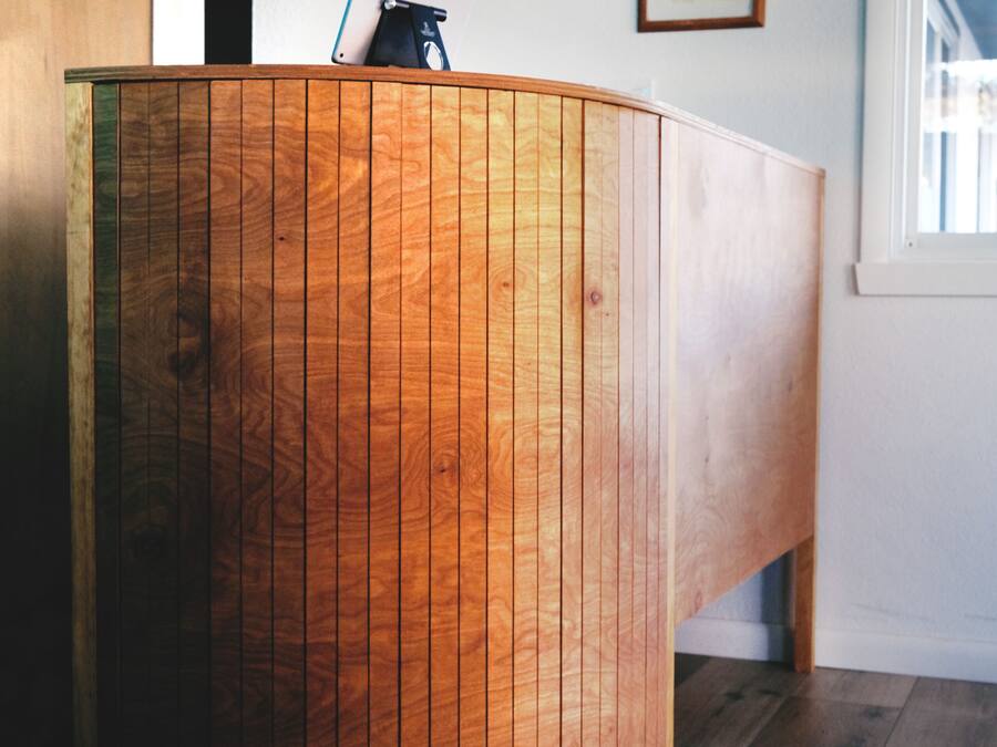 A wooden reception desk with a mounted deer head and a framed certificate on the wall.