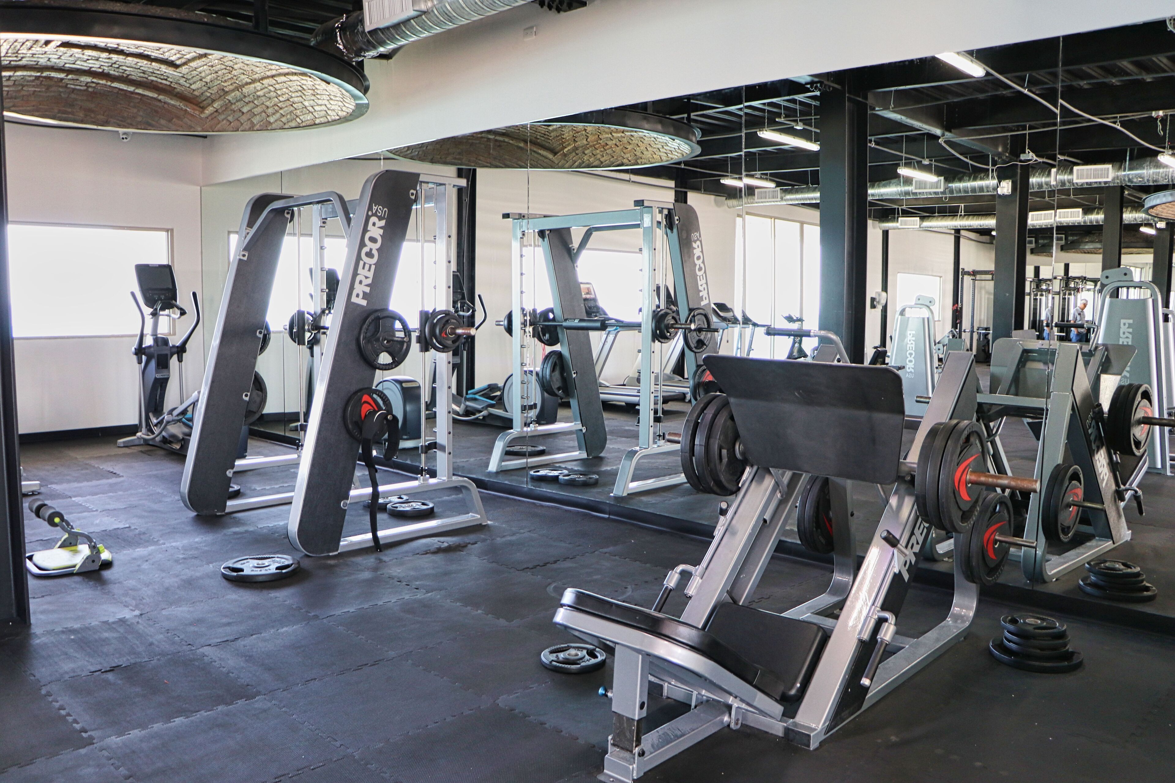 A gym with various exercise equipment, including treadmills and weight machines.