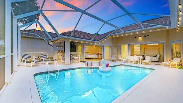 An indoor swimming pool with a clear view of the adjacent rooms, a ceiling fan, and a string of lights. - LUXURY Villa ALEXA Naples

Modern Voice controlled Villa with SALT WATER POOL (Naples)