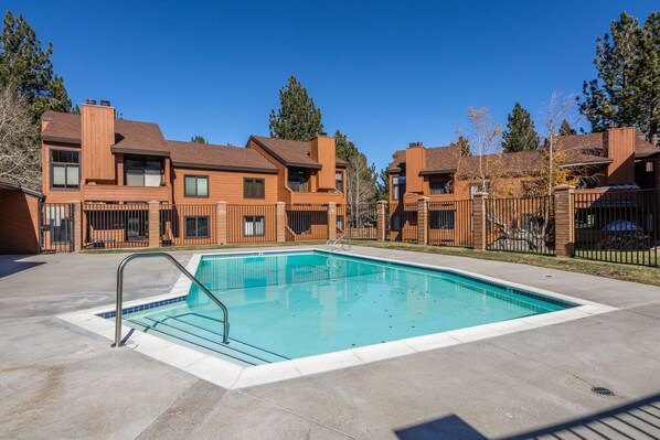 A modern apartment complex with a swimming pool, wooden exterior, and multiple balconies. - Sunrise 9 (Mammoth Lakes)