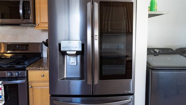 A stainless steel refrigerator with a water dispenser, a microwave, and a stove in a kitchen. - NORTH HOLLYWOOD GEM: 2BR HOME w/ PRIVATE HOT TUB, PATIO/YARD & EV CHARGER p42 (Los Angeles)
