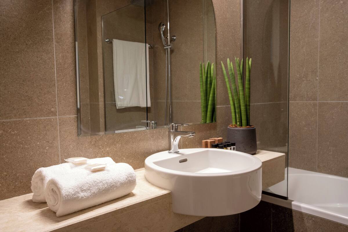 family room open plan | bathroom | free toiletries, hair dryer, bathrobes, slippers