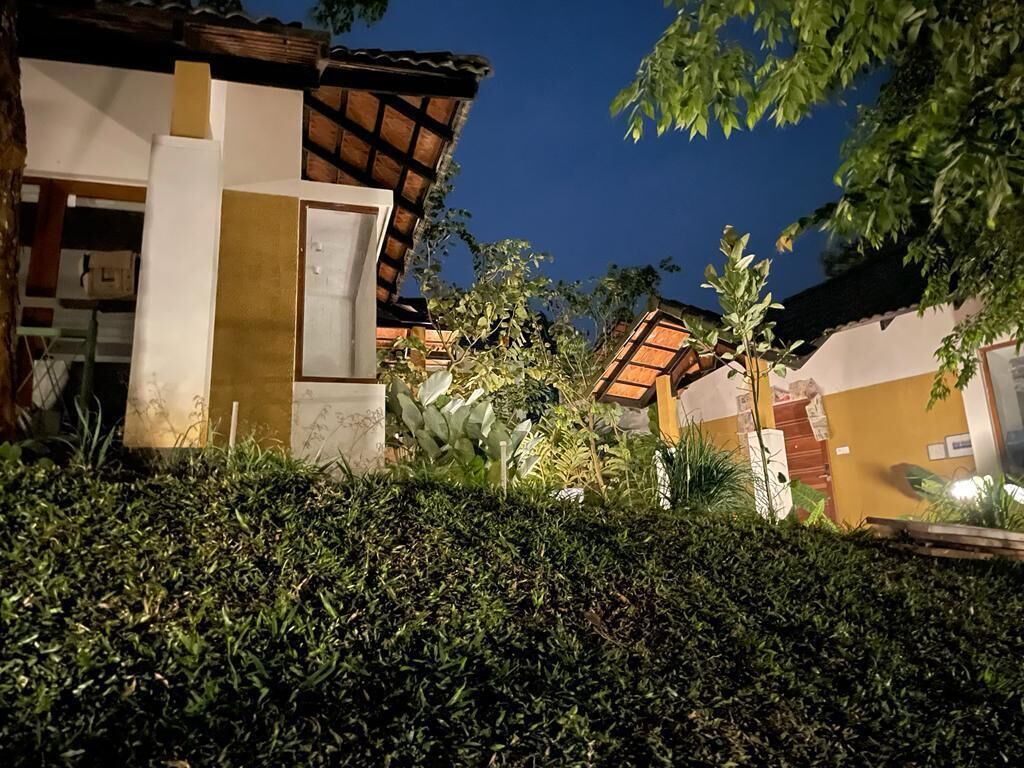 A residential area with a house featuring a tiled roof and a white facade.