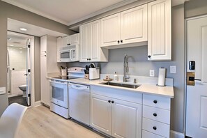 Enjoy cooking in this well-lit kitchen with appliances and a large window.