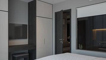 A modern bathroom with a large mirror, a built-in toilet, and a shower area.
