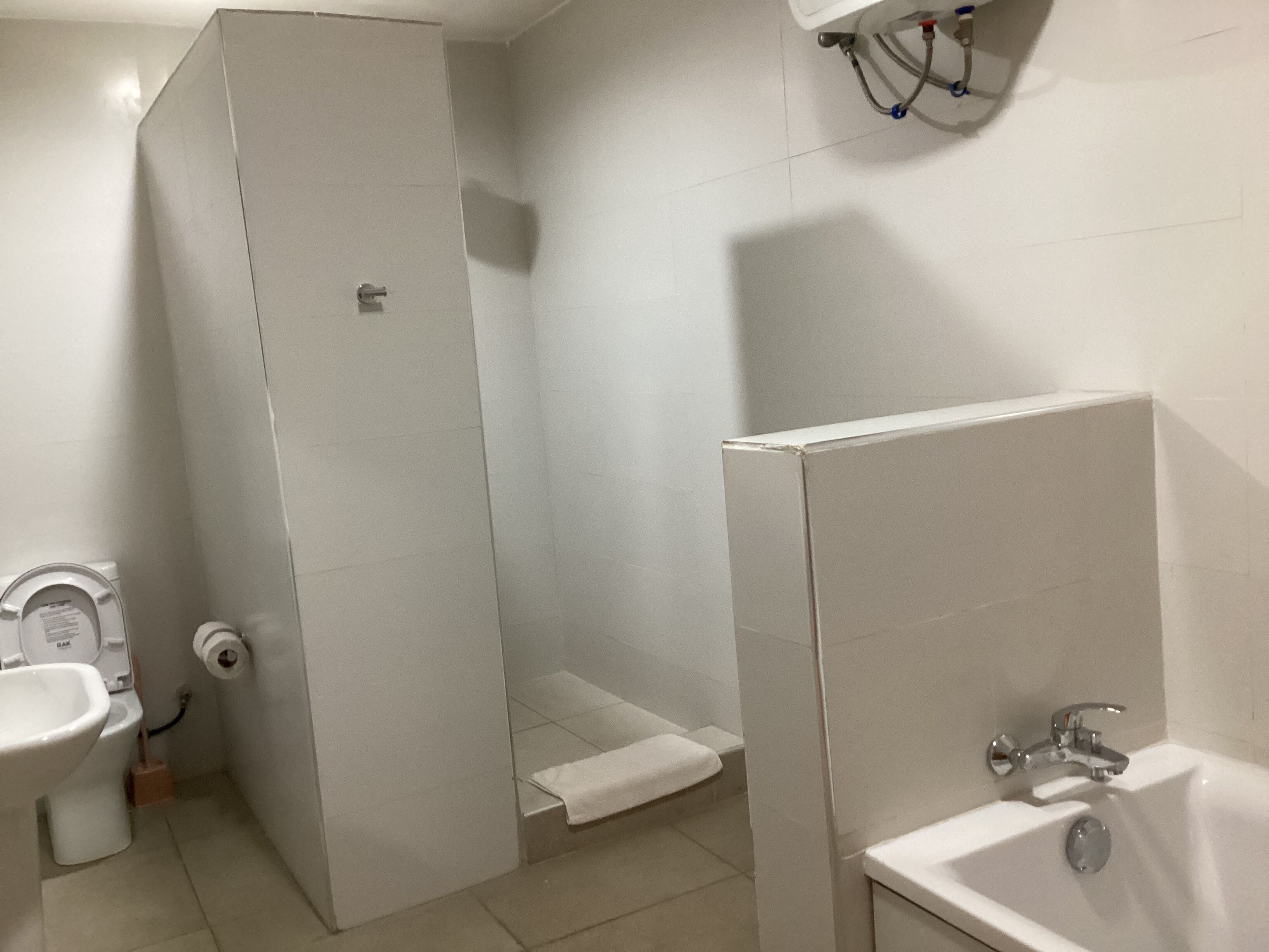 Un baño con inodoro, ducha y lavamanos.