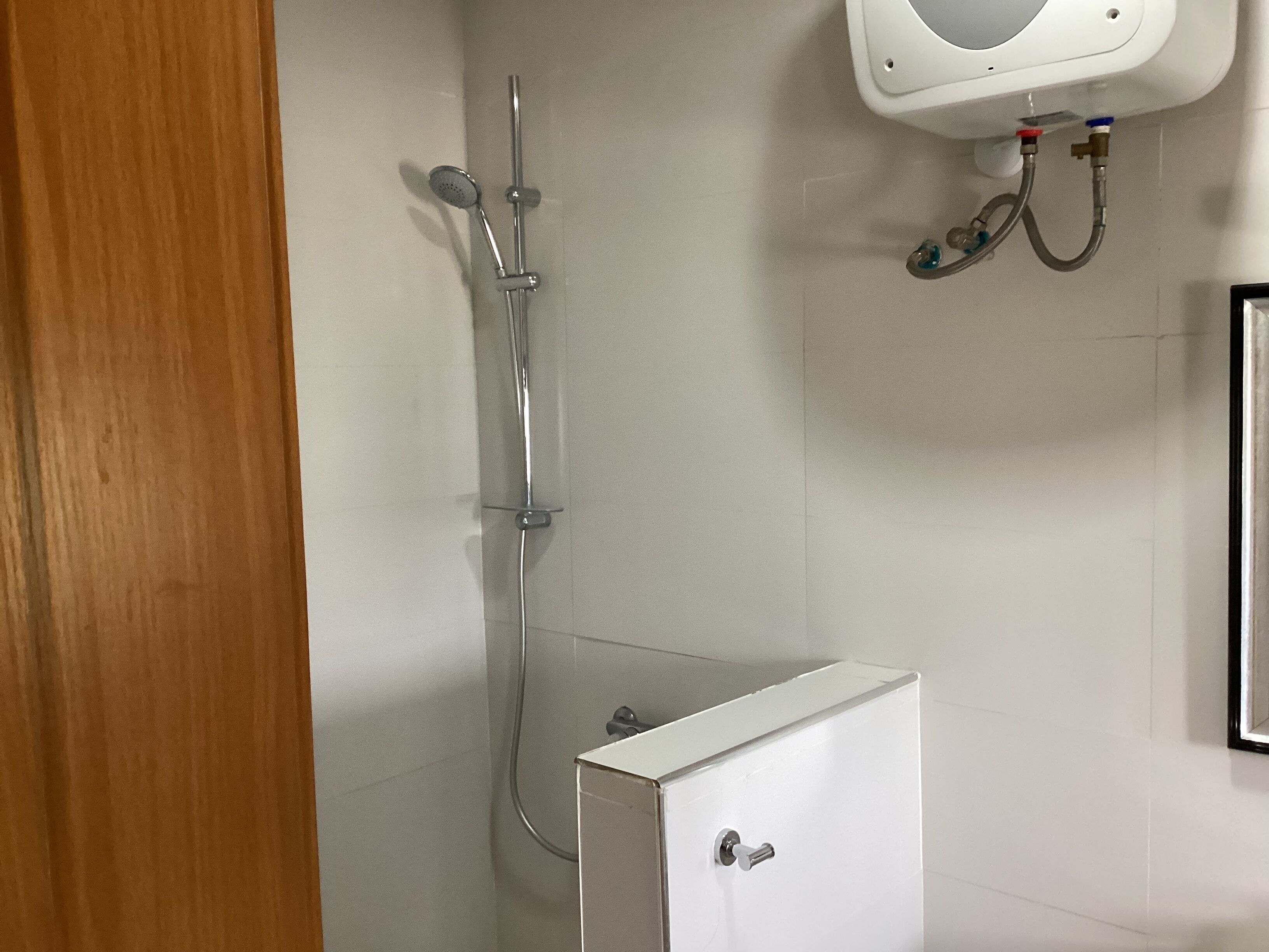 A bathroom with a shower, toilet, and sink.