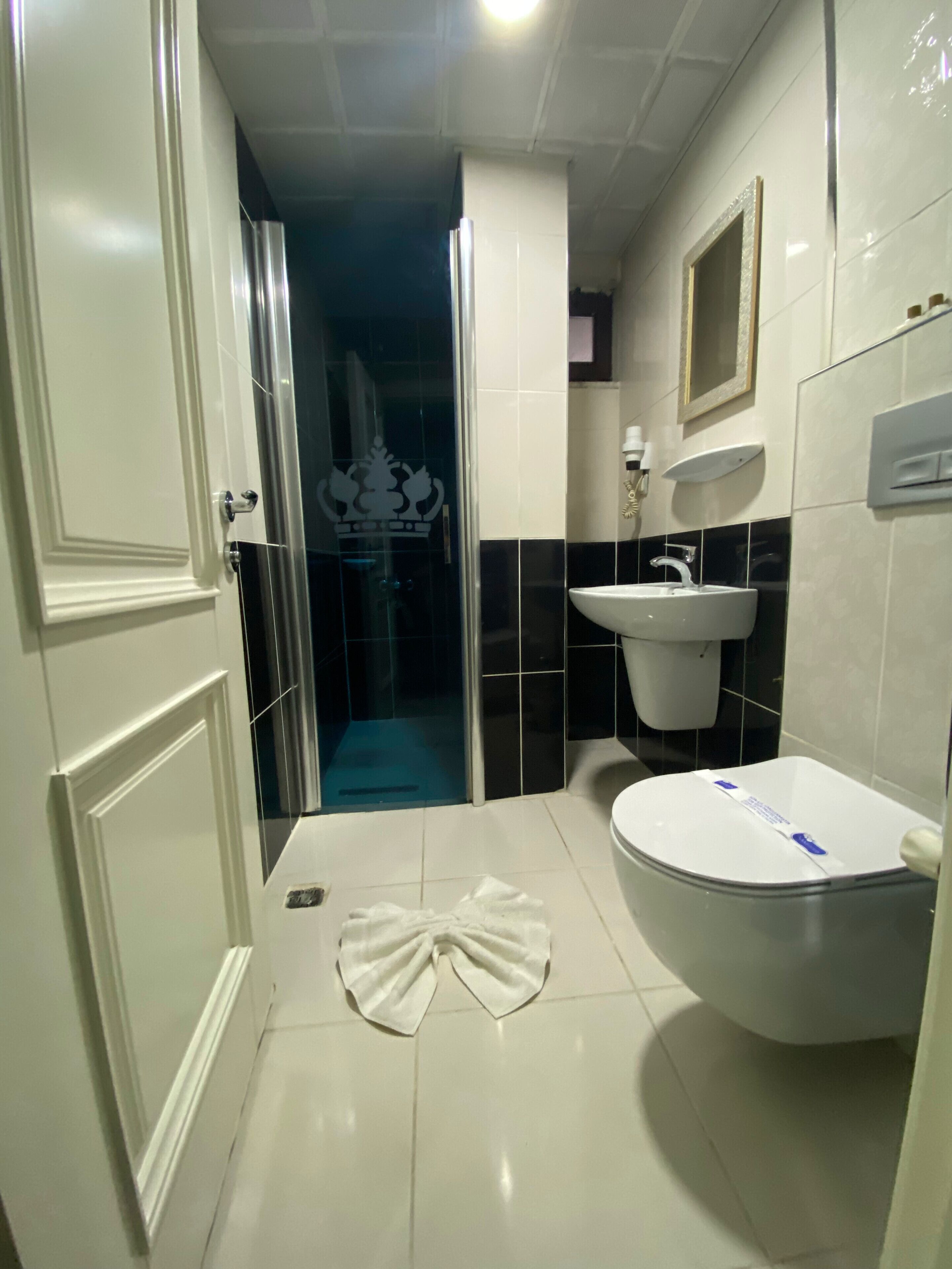 economy triple room, multiple beds | bathroom | shower, slippers, towels, soap