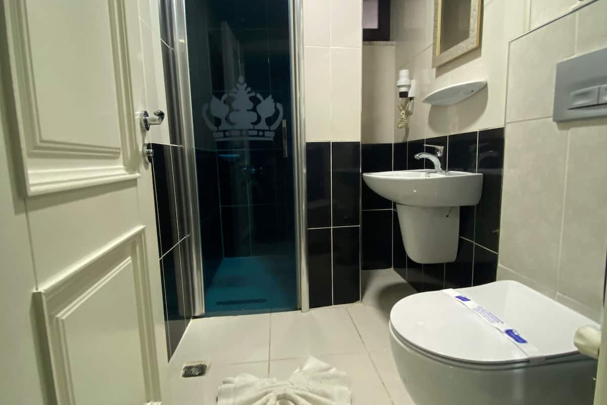 economy triple room, multiple beds | bathroom | shower, slippers, towels, soap