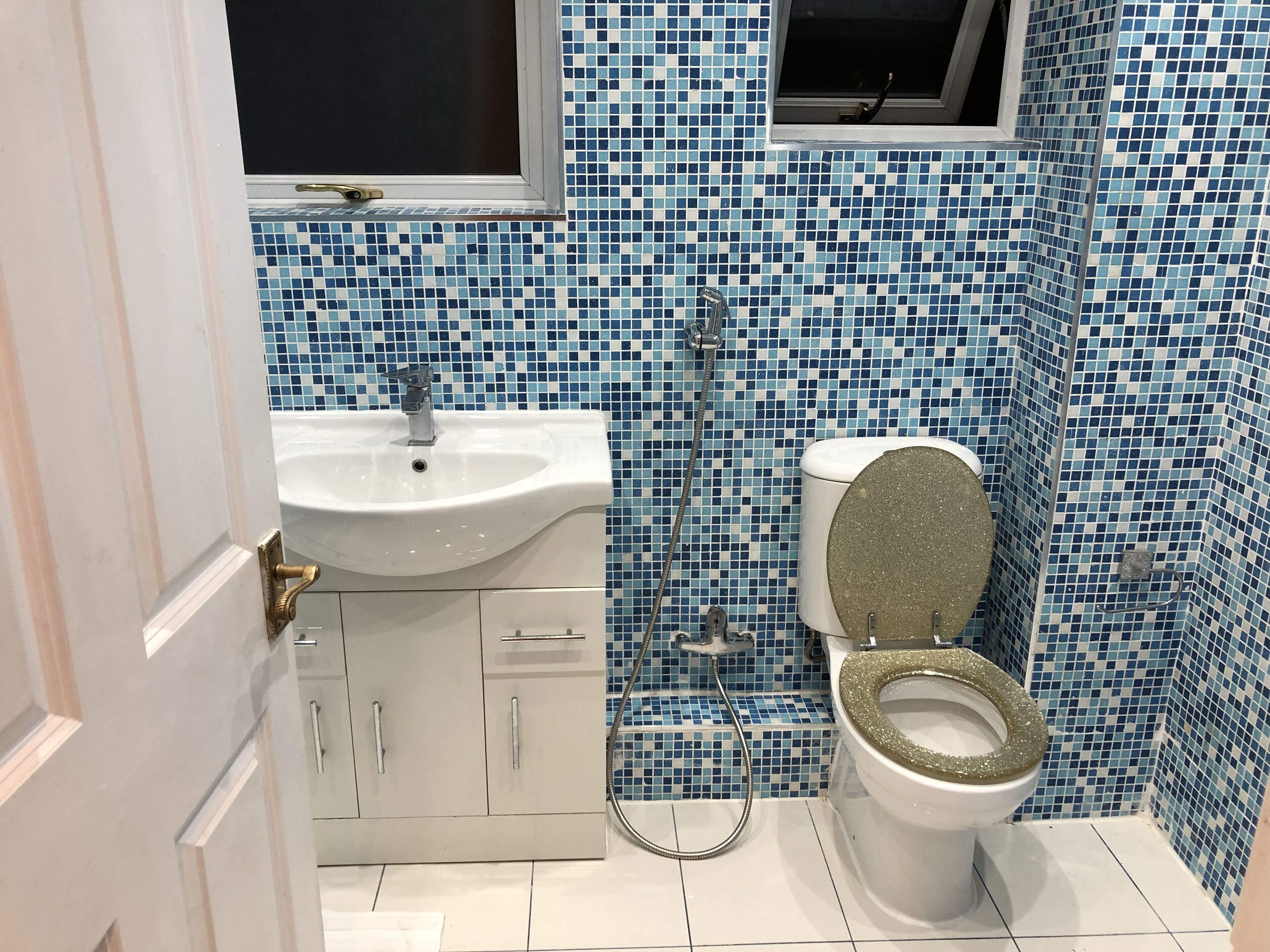 A bathroom with a sink, toilet, and shower.