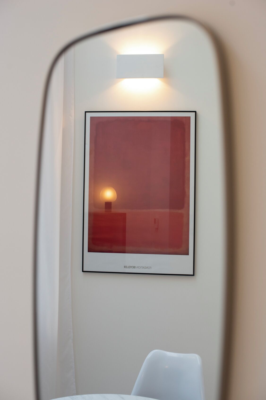 A framed picture with a light source behind it, mounted on a wall.