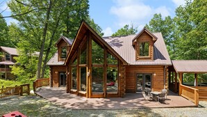 A log cabin with a large deck, outdoor seating, and a pool table. - Kozy Bear 3 King BRs | Hot Tub | Pool Table (Sevierville)
