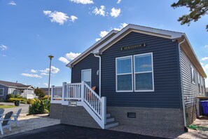 A single-story building with a dark exterior, white trim, and a nameplate reading 'SEACLUSION'.