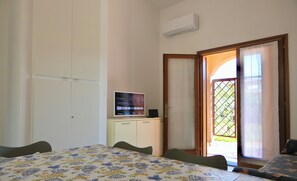 Family Apartment | Living area | 30-inch TV with cable channels - Appartamenti l'Avru (San Teodoro)