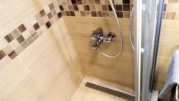 Apartment, 1 King Bed | Bathroom | Shower, hair dryer, towels