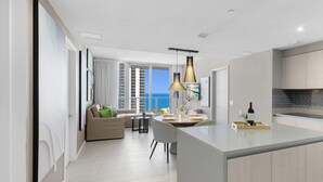 A modern apartment with a kitchen, dining area, and living room. - Front Ocean View: Amazing Pools (Hollywood)