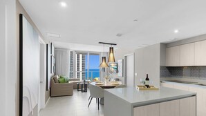 A modern apartment with a kitchen, dining area, and living room. - Breathtaking Front Ocean View: Amazing Pools (Hollywood)